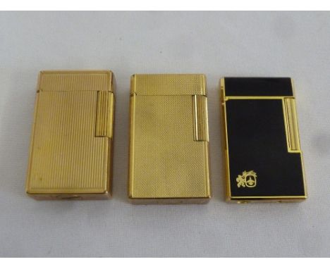 Two S T DuPont gilt metal lighters and a Collibri black enamelled lighter