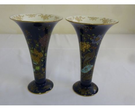 A pair of Carltonware vases, blue ground in the Chinese style on raised circular bases