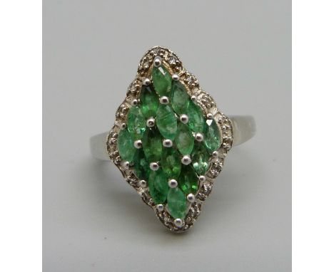 A silver and emerald dress ring with diamond accents, O 