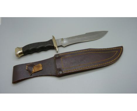 A Muelay dagger with saw back, made in Spain, with leather scabbard 