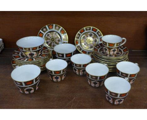 A collection of Royal Crown Derby 1128 pattern teawares, seven cups, four large and six small saucers and eleven tea plates o