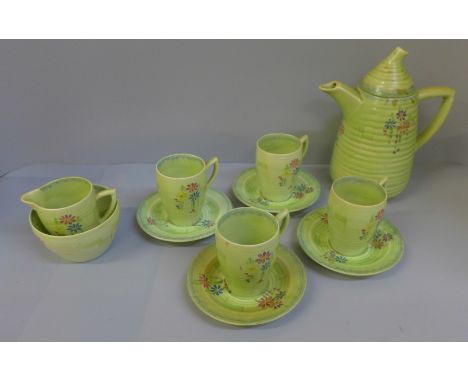 A Clarice Cliff Bizzare coffee set, four cups (one cup, chip to rim, one cup handle re-glued), four saucers, milk and sugar a