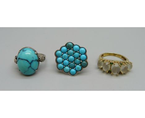 A silver and moonstone ring and two silver and turquoise rings 