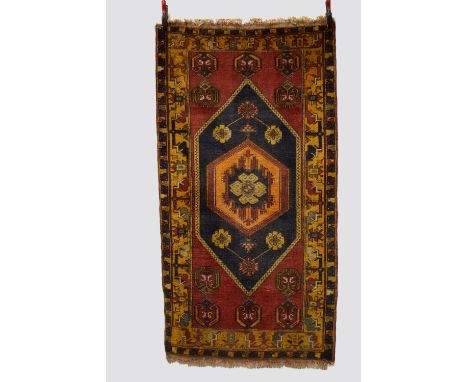 Four rugs, the first: Konya rug, central Anatolia, circa 1930s-40s, 6ft. 6in. X 3ft. 6in. 1.98m. X 1.07m. Overall wear. Dark 