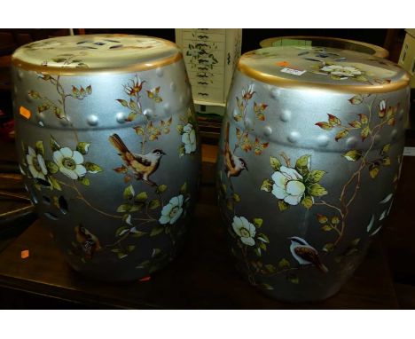 A pair of Chinese style silvered and polychrome painted ceramic barrel garden seats, each height 45cm