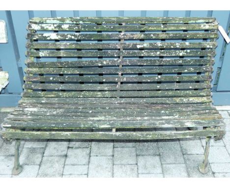 An early 20th century cast iron ended and wood slatted two seater garden bench (for restoration), width 125cm