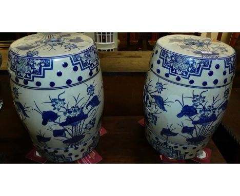 A pair of contemporary Chinese style blue &amp; white glazed stoneware barrel garden seats, each height 43.5cm