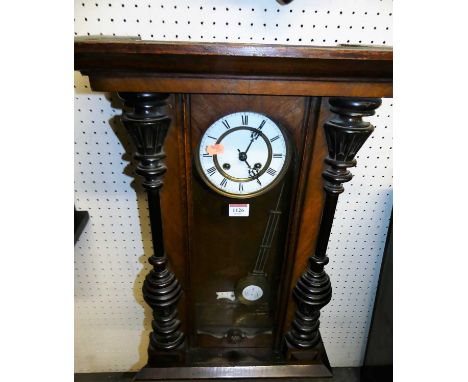 An early 20th century walnut drop trunk wall clock with pendulum, height 70cm