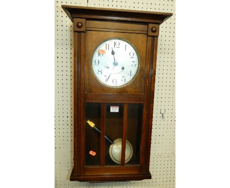 An early 20th century walnut drop trunk wall clock with pendulum, height 70cm