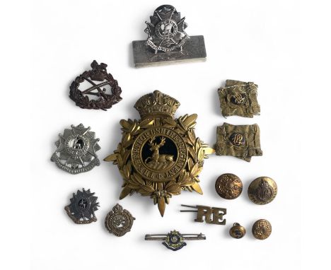 A collection of badges and buttons for The Hertfordshire Regiment and The Bedfordshire and Hertfordshire Regiment, to include