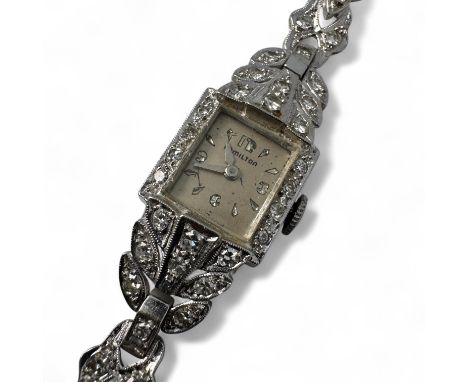 A diamond and white precious metal Art Deco Hamilton cocktail watch. On a cord and leather strap. Stamped 14K to the rear of 