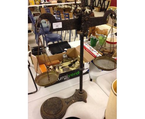 Victorian cast iron balance scales with brass pans. Bears an official calibration stamp showing a Crown GR 174. Has an indist