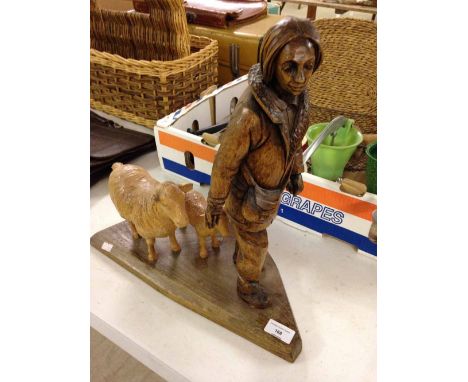 A wooden carving of a shepherd with a sheep & lamp. 40cm tall.