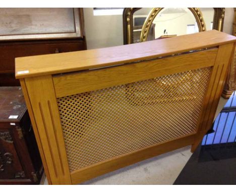 A light coloured radiator cabinet 110cm wide x 82cm tall.