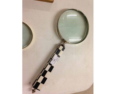 Large magnifying glass with art deco checkerboard style handle.