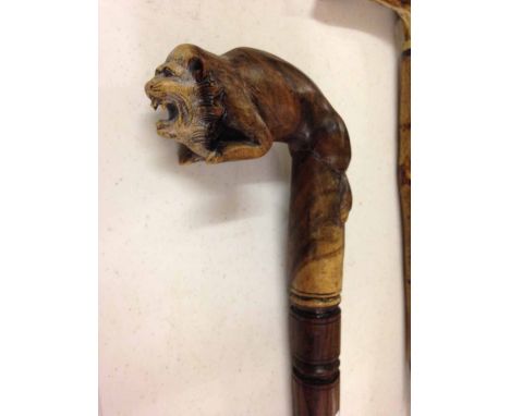 A walking stick with carved wooden oriental lion handle