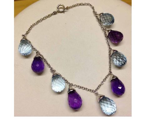 18ct white gold chain bracelet with 4 amethyst & 5 blue topaz faceted stones suspended.