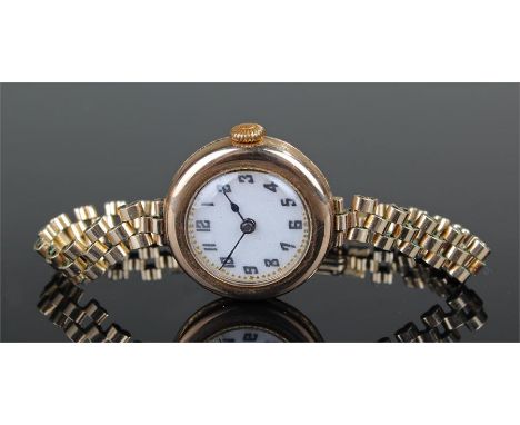 Ladies 9 carat gold wristwatch, the white enamel dial with Arabic hours, rolled gold strap, case 25mm diameter