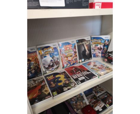 Shelf of nintendo wii games . 