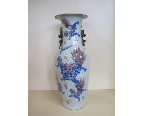 A large Chinese 19th century porcelain vase decorated with Fu dogs in an iron red and blue glaze, in a crackle ground - seal 