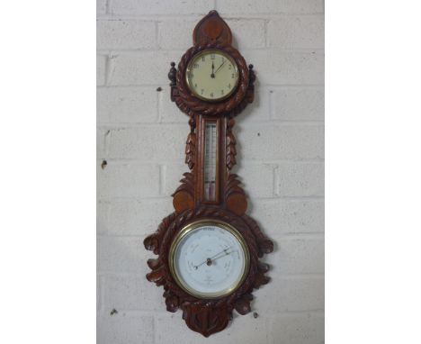 A late Victorian walnut barometer clock with thermometer, extensively carved with a nautical theme, height 64cm, width 25cm -