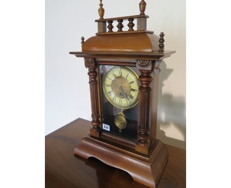 A Victorian mixed wood/glazed pendulum mantle clock with brass and enamel face - running in saleroom 