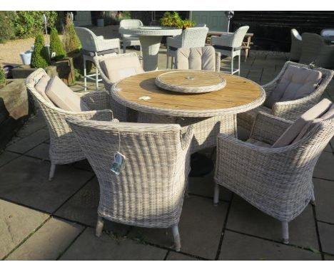 A Bramblecrest Ascot dining set, table 140cm with ceramic top, lazy Susan and six armchairs, ex-display 