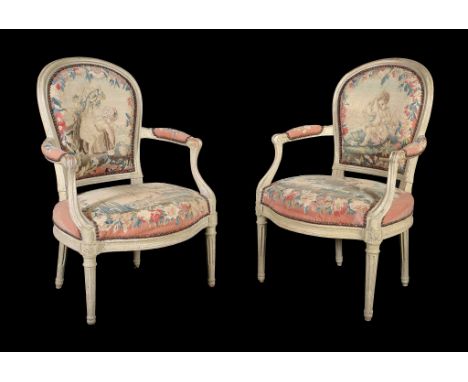  A pair of Louis XVI grey painted and tapestry upholstered armchairs,   circa 1775,  the moulded frames incorporating padded 