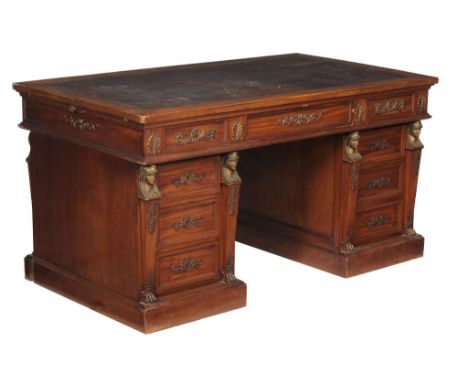  A Napoleon III mahogany and gilt metal mounted partners pedestal desk,   circa 1870, in the Empire taste, decorated with gil