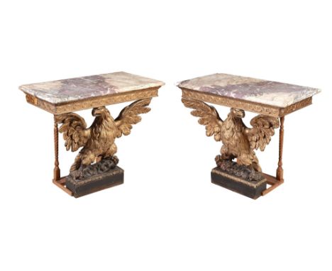  A pair of carved giltwood console tables,   circa 1740 and later, each breche violette marble top above a moulded Vitruvian 