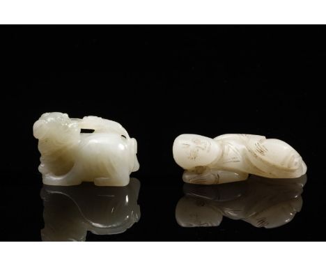 Chinese Art Two jade carvings shaped as a child and a lion China, 19th century . . Cm 5,00 x 1,00.