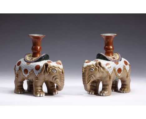 Chinese Art A pair of elephant shaped pottery candlesticks bearing a Qianlong six character seal mark at the base China, 19th