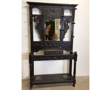 Victorian stained oak and pine hall stand with carved dragons and foliage central mirror with bevelled edge with door to stor