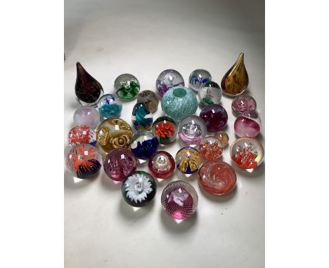 A collection of glass paperweights to include Caithness and other makers.