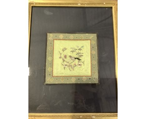 A framed Oriental embroidered square silk panel depicting a bird amongst foliage. W:34cm x H:42cm