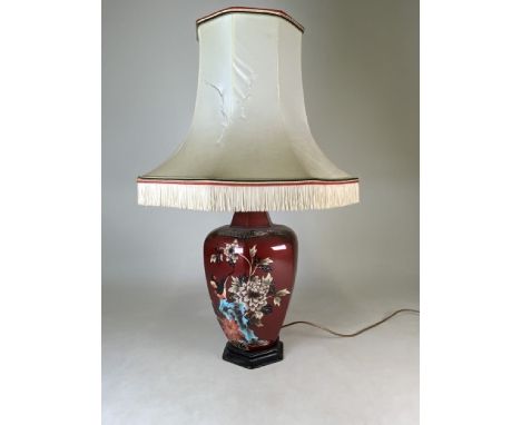 A large modern table lamp decorated with birds and flowers.