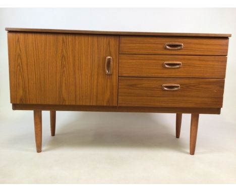 A mid century sideboard by Schreiber. Cupboard to shelf along side three drawers.   W:122cm x D:43cm x H:73cm