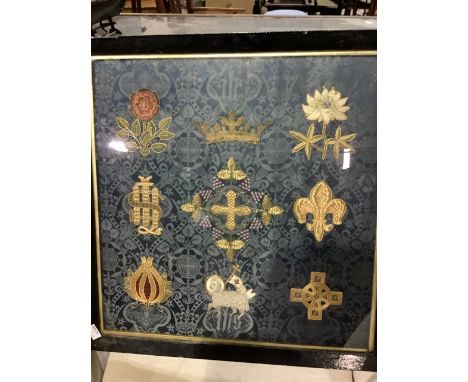 A silk embroidered framed panel of heraldic motifs.   W:52cm x H:54cm