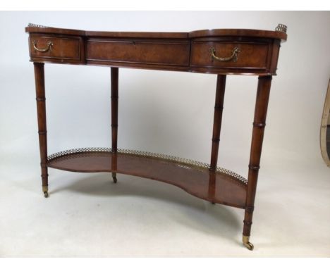 A Brights of Nettlebed walnut reproduction kidney shaped ladies writing desk with leather top and brass gallery, two side dra