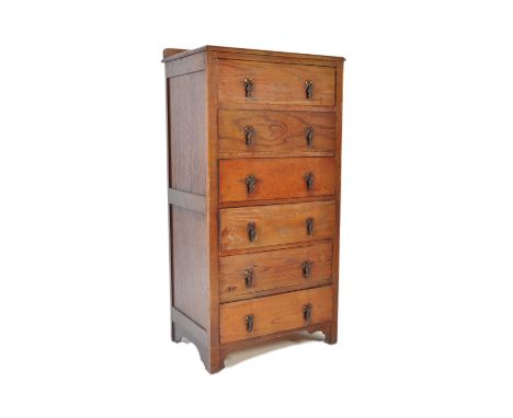 A vintage 20th century circa 1940s oak tall boy pedestal chest of drawers having a flared top over a bank of six drawers with