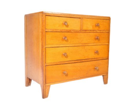 A retro vintage mid 20th Century light blonde oak chest of drawers. Of rectangular form two over three drawers with dovetail 