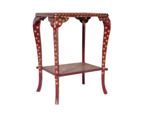 An early 20th Century Chinese red lacquered side / lamp table / occasional table having gilt burst motifs throughout with a d