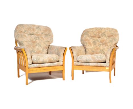 Ercol - Renaissance - A pair of vintage retro mid 20th century Ercol manner armchairs having cushioned backrest and seat pad 