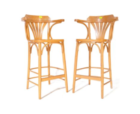 A pair of retro vintage mid 20th Century beech and ash Thonet style bentwood bar stool chairs. Gallery back with curved arm r