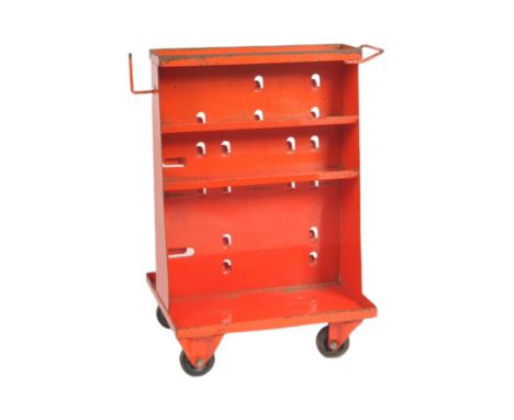 A retro vintage mid 20th Century industrial red metal engineering trolley / tool trolley. Angular A frame form with wheeled l