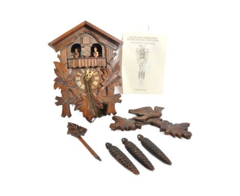 A vintage 20th century wooden Danbury Mint Black Forest Cuckoo clock with articulated moving characters to top &amp; roman nu