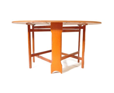 A retro vintage 20th century teak drop leaf dining space saver table of oval shaped raised on shaped slat supports.&nbsp;Meas
