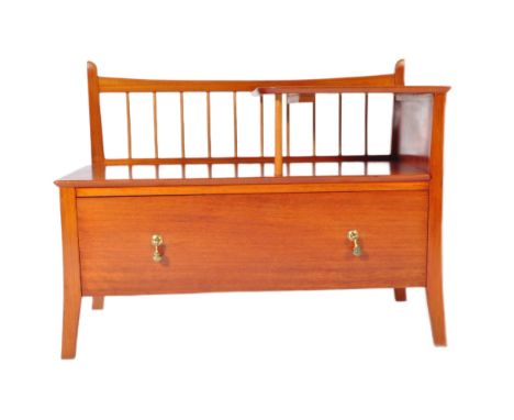 A retro vintage mid 20th Century teak hall settle bench. Of rectangular form having a pierced spindle back with upper tier pl