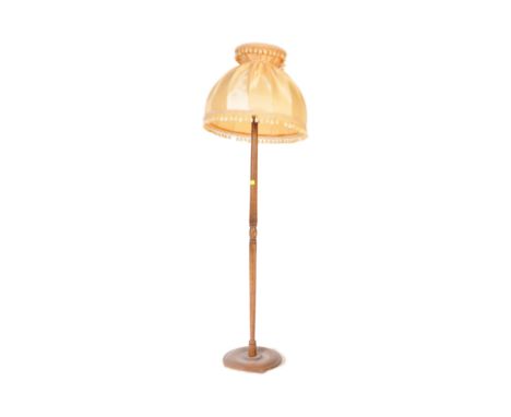 A vintage mid 20th century circa 1940s mahogany floor standard lamp with shade. The lamp having a turned column with central 