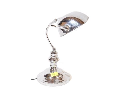 A vintage retro mid 20th century chrome bankers lamp raised over a circular stepped base.&nbsp;Measures approx; 35cm x 26cm x